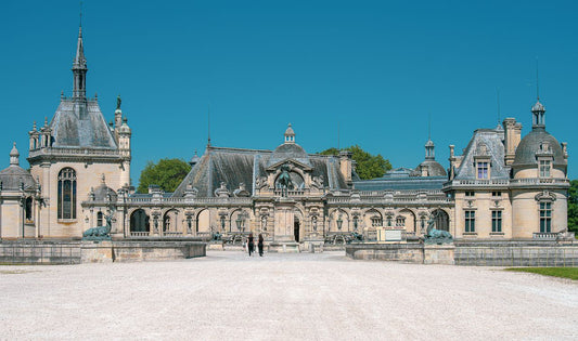 Unlimited eSIM France; scenic historic palace in France under a clear blue sky.