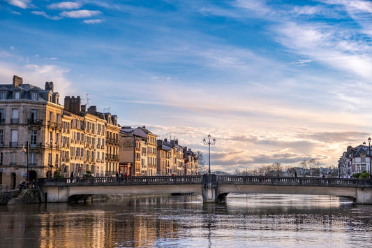 Best eSIM for France; scene in Paris France showing the Seine River with a bridge under a blue sky.