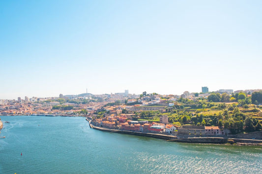 eSIM for Portugal travel; a scenic city scape in Portugal showing a blue river winding through a town in Portugal