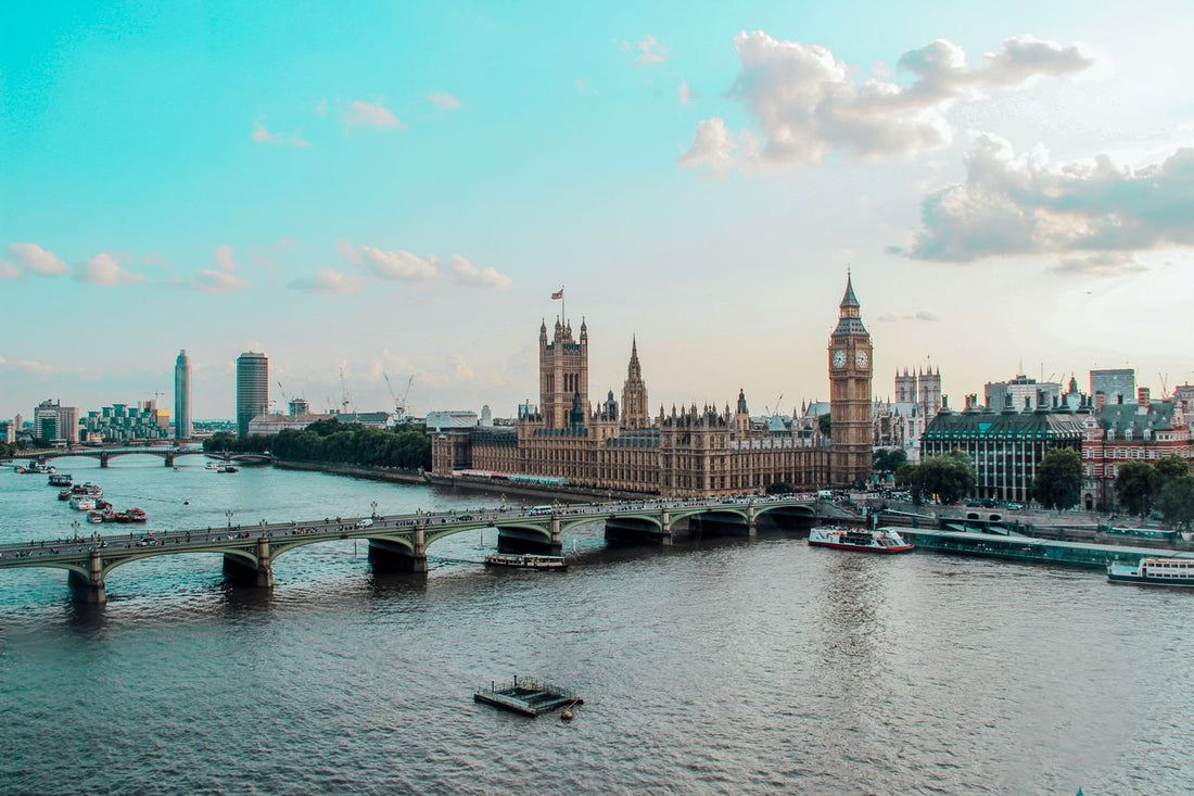 UK travel eSIM; photo of the skyline of London, UK, with the Thames River in the foreground and the House of Parliament in the background.