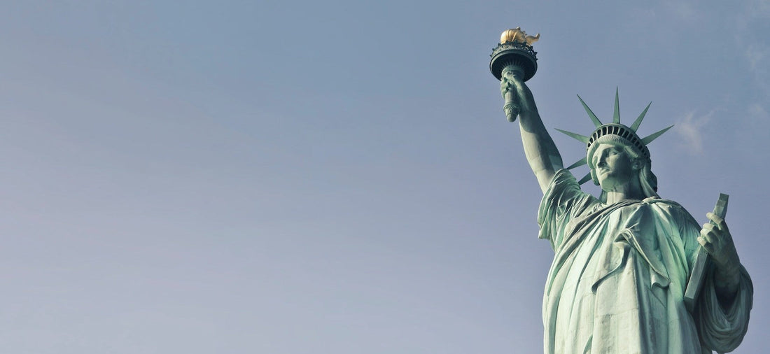 Best eSIM for USA travel; photograph of the Statue of Libert against a clear blue sky.