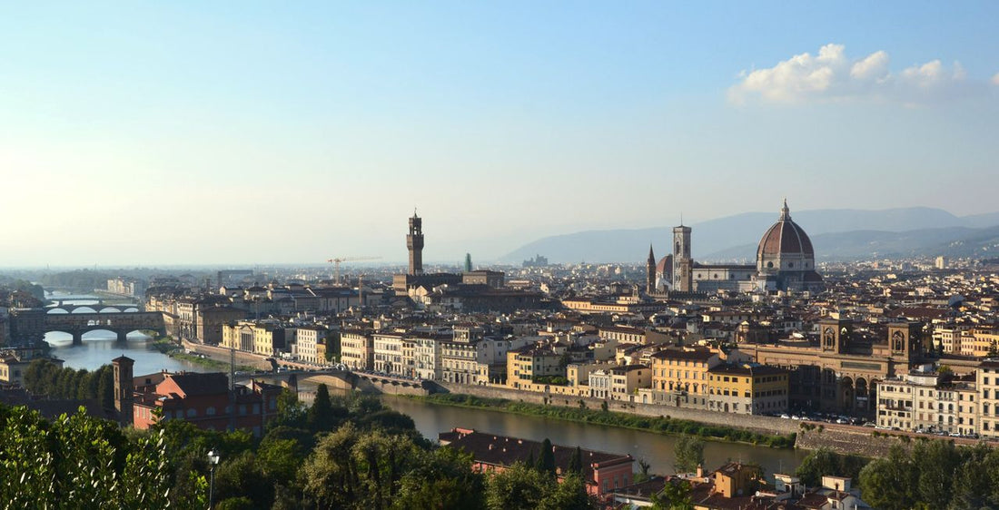 Italy Mobile Data Plan: cityscape scene of Florence, Italy under a blue partially cloud sky.