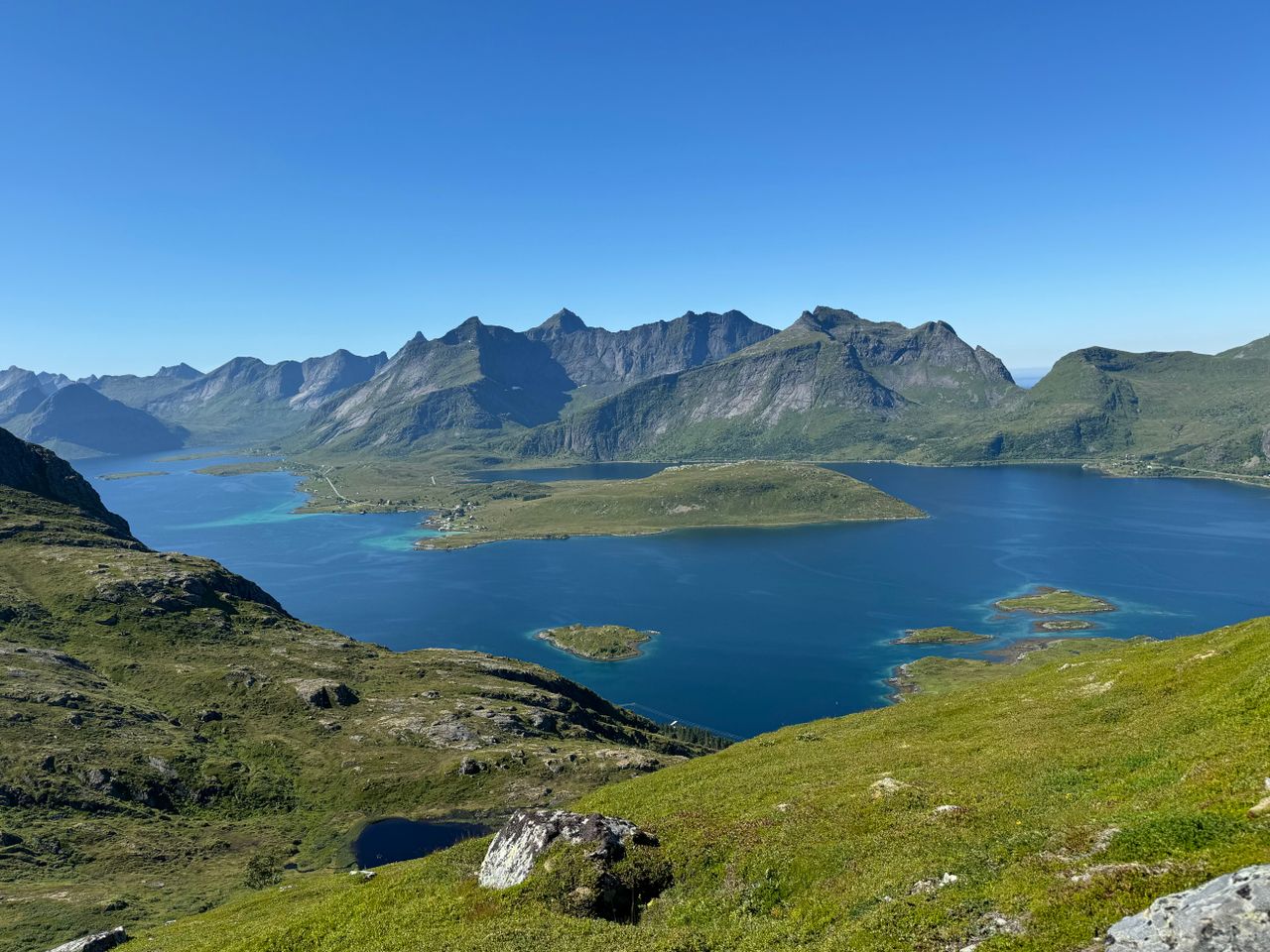 Best Aland Islands eSIM for travel; scenic view in the Aland Islands of a deep blue fjord winding between rugged green mountains.