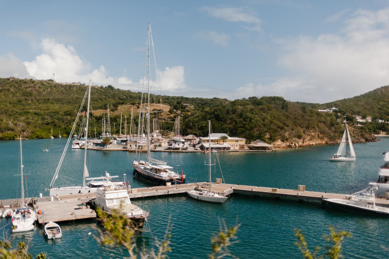 Best eSIM for Antigua and Barbuda; a marina in a bay in Antigua and Barbuda with forested hills in the background.