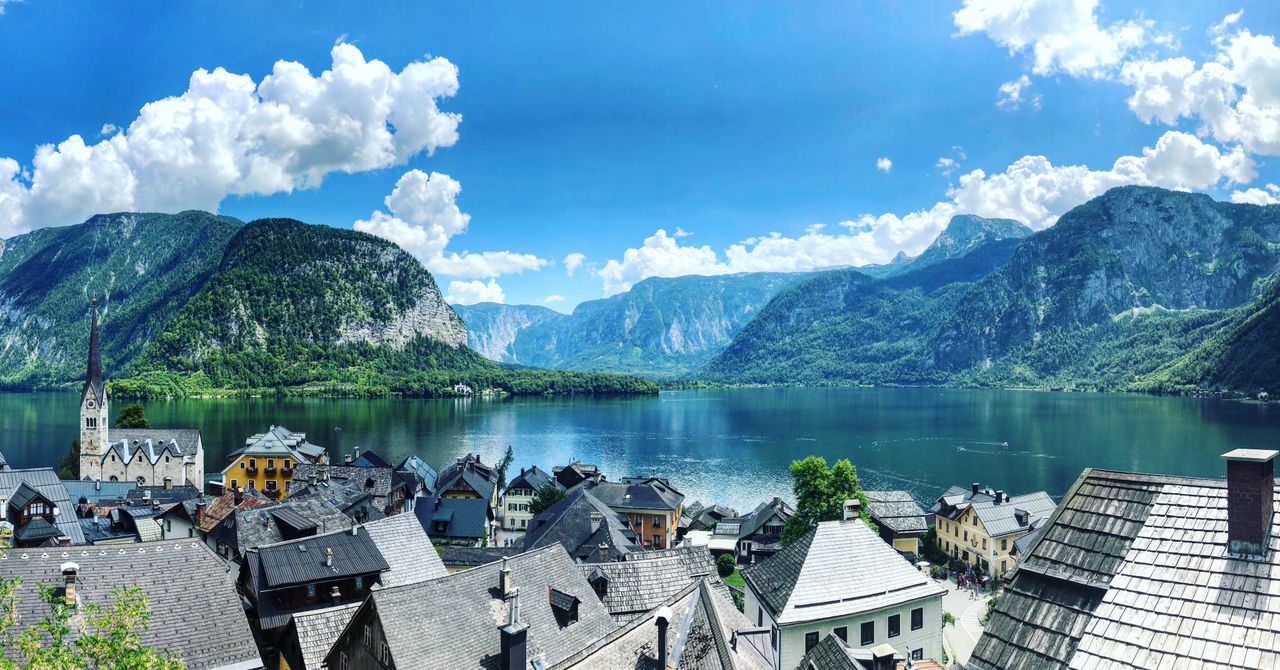 Best Austria eSIM plan for travel - photo of an Austrian village with lake and mountains in the background.