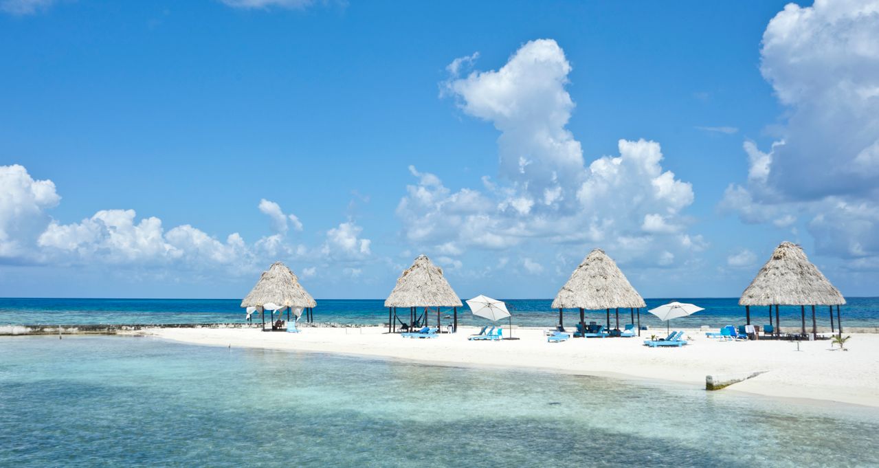 Best Belize eSIM - photo of Belize sandy white beaches adorned with beach huts