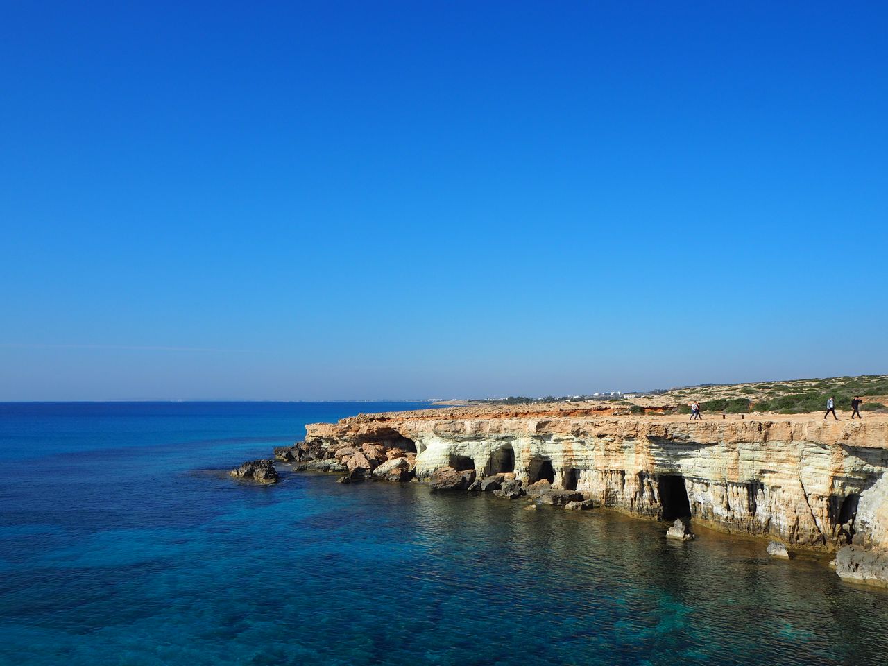 Cyprus eSIM plans for tourists - photo of rocky Cyprus coastline with blue ocean in the foreground.
