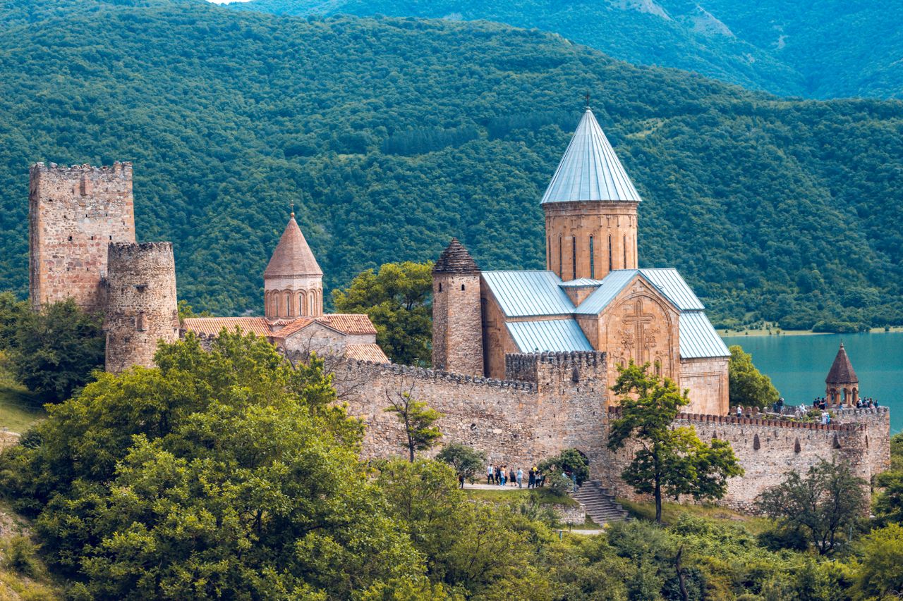 Best eSIM for Georgia travel - photo of an old church and castle walls in Georgia
