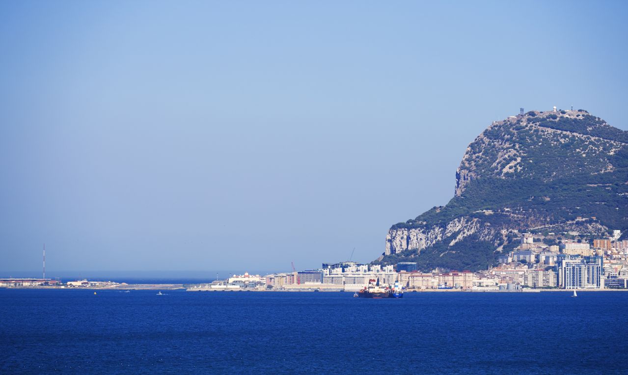 Best eSIM for Gibraltar - photo of Gibraltar with sea in foreground and the Rock of Gibraltar in the background