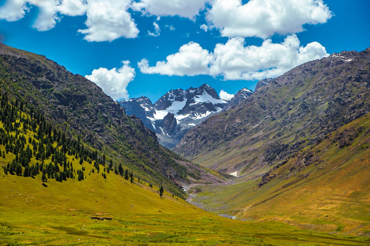 Best Kyrgyzstan eSIM for travel; a valley between mountains with snow peaks.