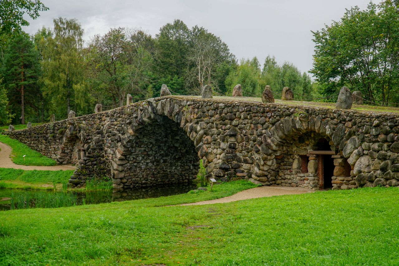 Best Lithuania eSIM for travel - A stone bridge with multiple arches spanning a narrow waterway in Lithuania.