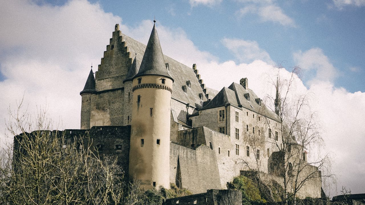 Best Luxembourg eSIM for travel - photo of medieval castle with large stone walls in Luxembourg.