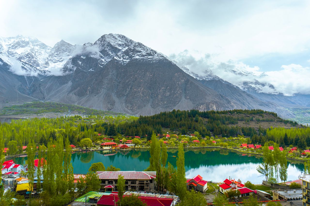 Best Pakistan eSIM - photo of Pakistan mountain village around a scenic lake with mountains in the background.