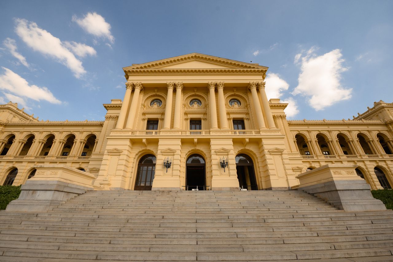 Best Paraguay eSIM for travel; a grand neoclassical stone building in Paraguay with a wide staircase leading up to a central entrance.