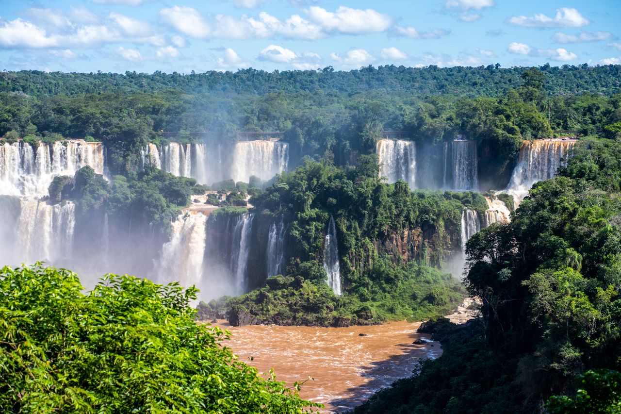 Best eSIM for PAraguay travel; a scenic view of Iguazu Falls in Paraguay with waterfalls and lush greenery.