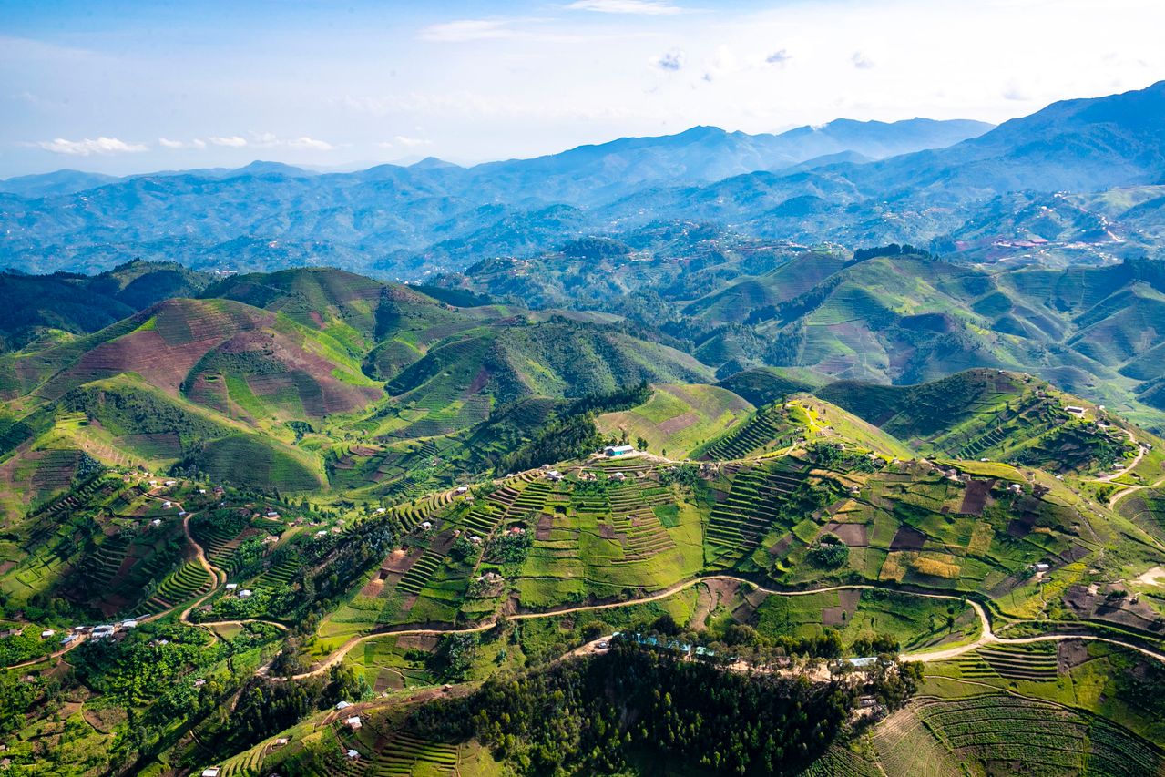 Best eSIM Republic of the Congo; a green mountain-scape in Congo with terraced green farm fields.