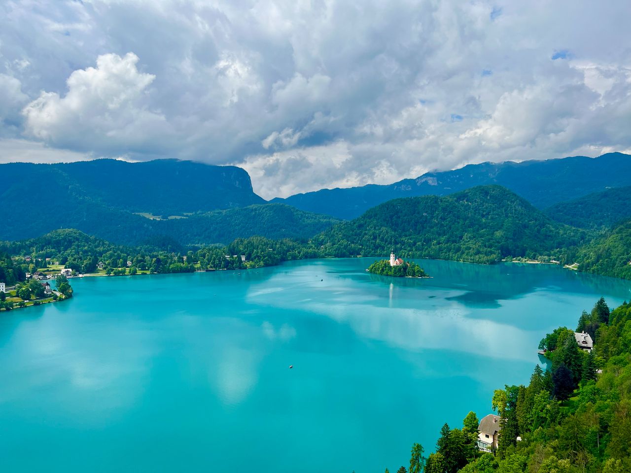 Best Slovenia eSIM plan for travel - photo of a picturesque Slovenia lake with mountains in the background